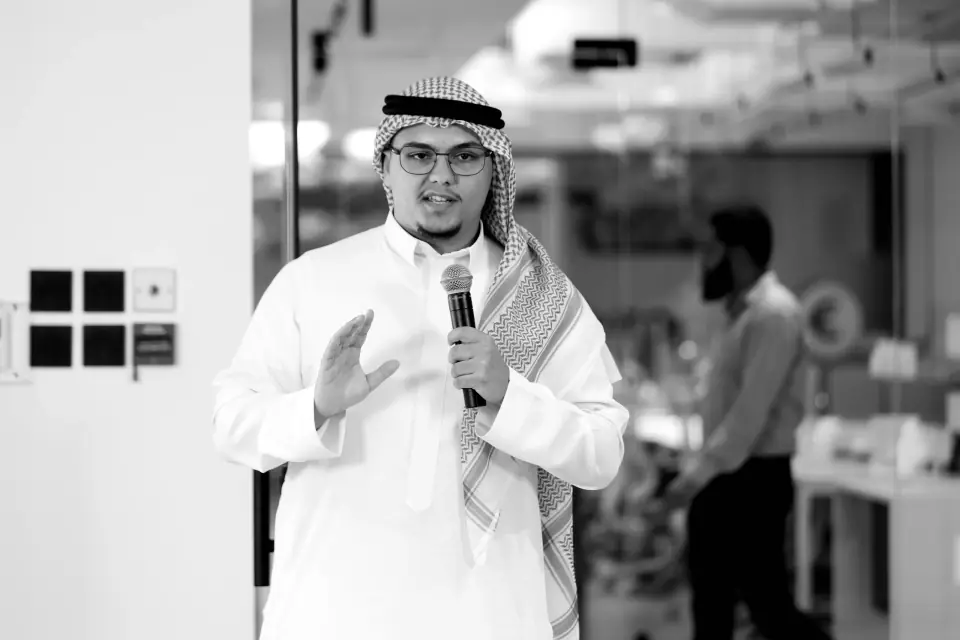 Rayan mid-talk with a microphone